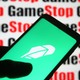 The Robinhood logo displayed in front of the logo of meme stock Gamestop, February 2021.